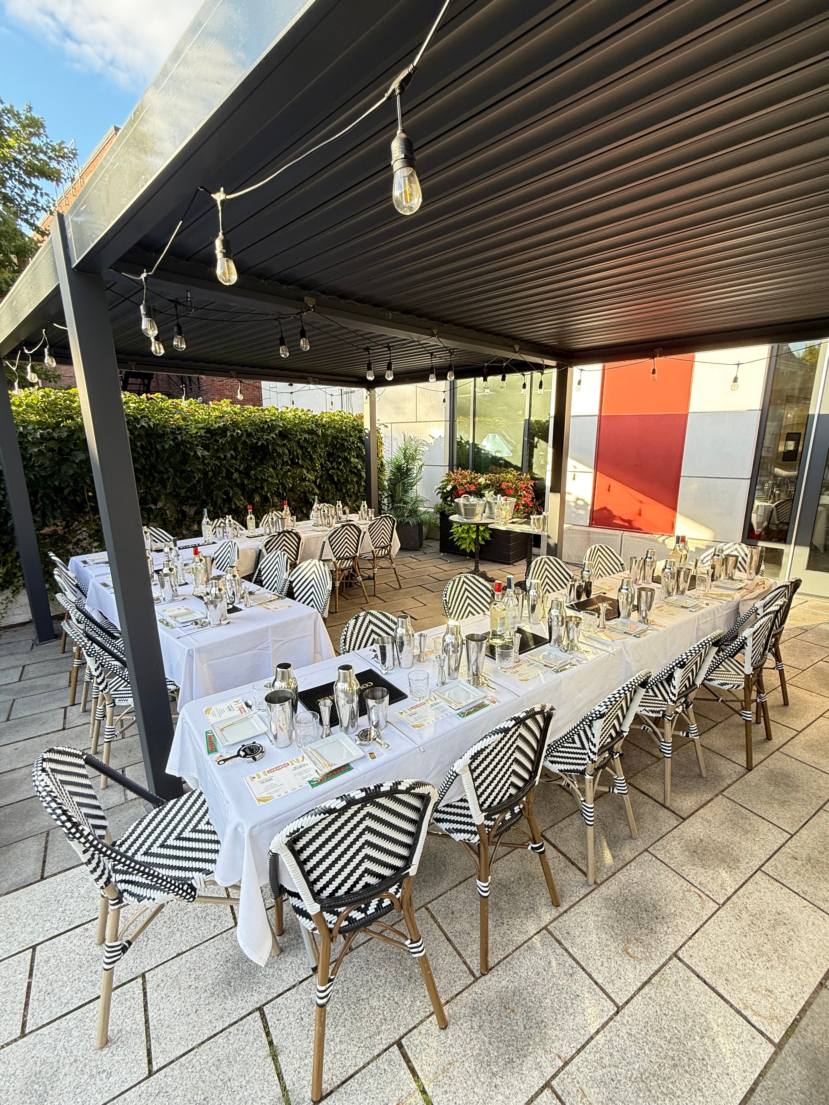 A long outdoor dinner table set for a Junto dinner