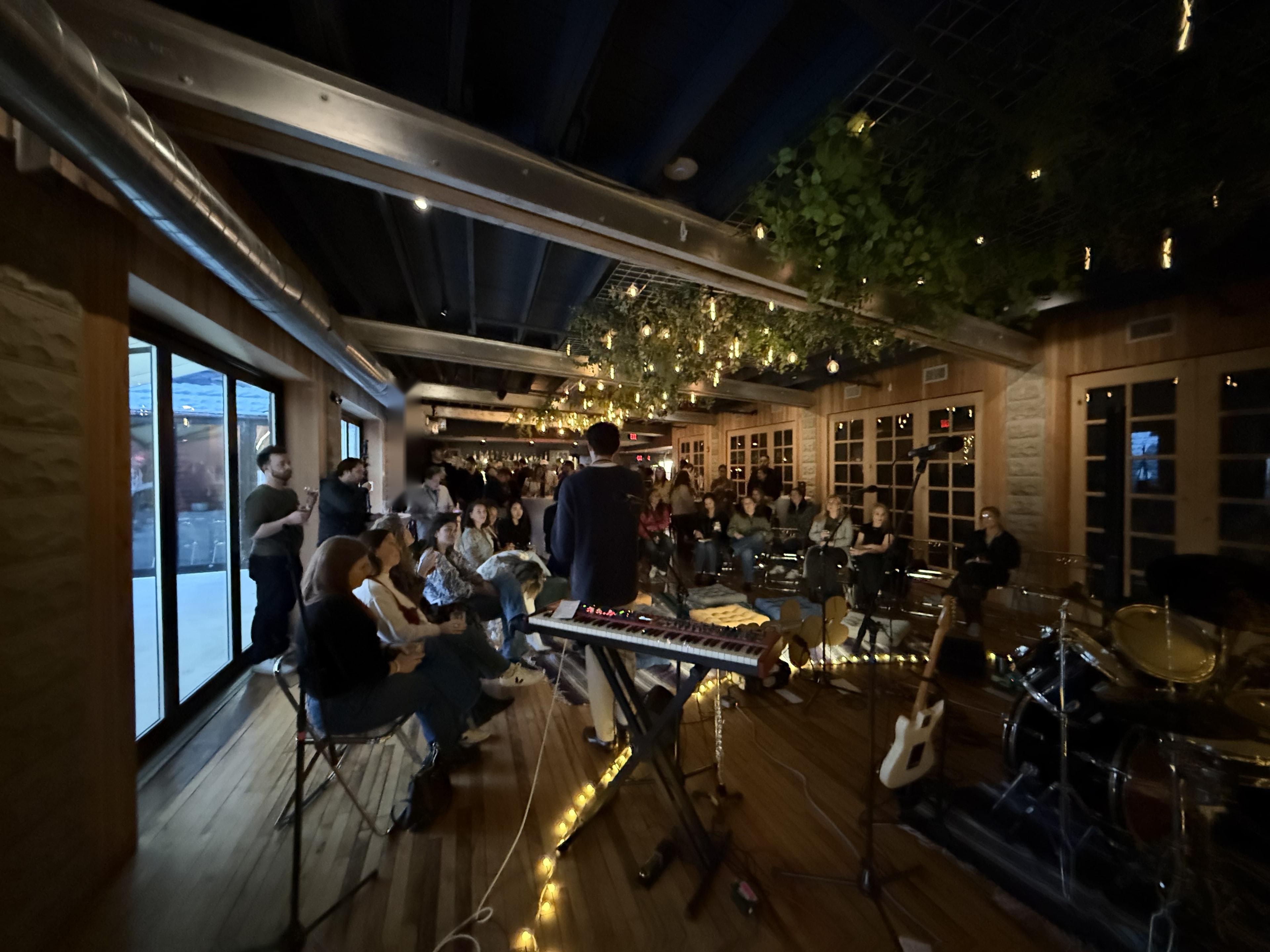 Junto rooftop social with Boston skyline at sunset